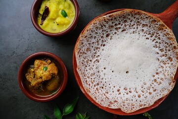 Appam or Vellayappam - Kerala breakfast Palappam served with potato stew and chicken curry