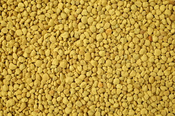 Golden bee pollen granules abstract background