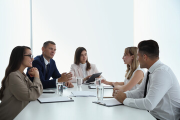 Office employees talking at table during meeting