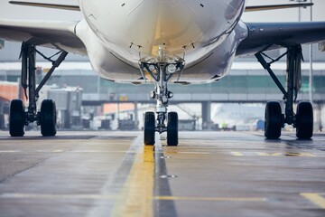 Front view of plane at airport. Commercial airplane taxiing to runway before take off. 