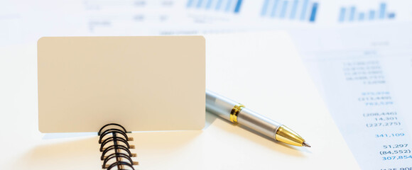 Blank business card for text on notepad with pen in office