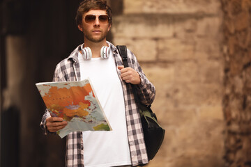 Traveler with world map on city street