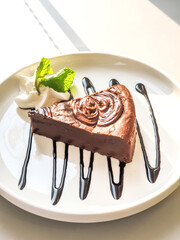 Chocolate cake served with cream on a plate
