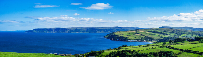 Wide panorama of Atlantic coast in County Antrim, Northern Ireland, UK, with bays, peninsulas,...