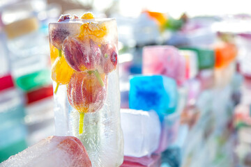 Frozen fresh flowers, air bubbles in an ice cube.
Flower in ice