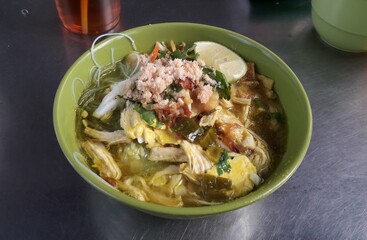 Soto dish with sweet and sour yellow seasoning with chicken and egg slices