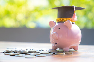 Piggy bank in graduation with money coin, Saving money for education