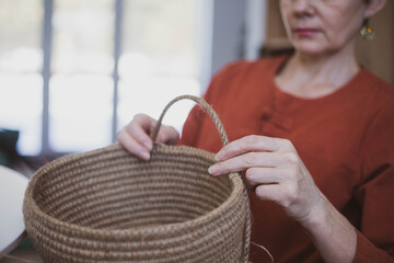 The woman is crocheting from environmentally friendly materials. Jute fiber for home decor. Home...