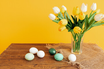Easter eggs bouquet of flowers Spring holiday yellow background