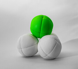 white and green juggling balls on white background