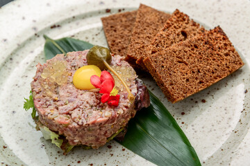Gourmet tartar raw from beef fillet with yellow egg