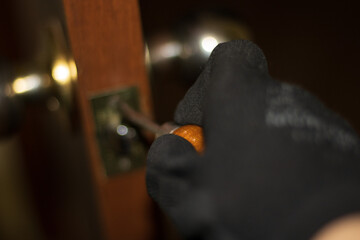 Man is installing the doors handle. Repair works. Maintenance in the apartment. Renovation in home.