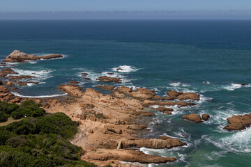 Areal view of a rocky coastline and blue ocean at The Heads, Knysna

