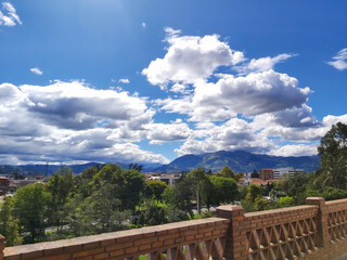Fototapeta na wymiar Mountainous landscape, part of the city of Cuenca, seen from a reddish brick balcony.