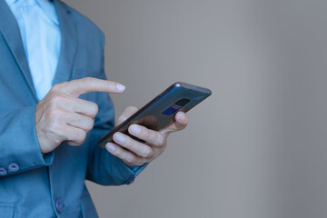 close up of business man hand using smart phone touch on screen and typing for some searching internet information technology data.