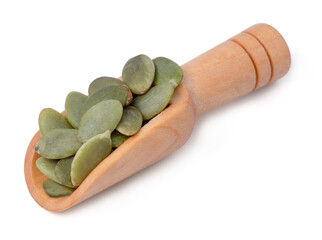 Raw pumpkin seeds on wood scoop organic food  ingredients.