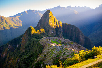 The first rays of the sun on Machu Picchu , the lost city of inca - Peru