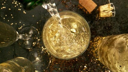 Super slow motion of pouring champagne into glass with camera motion. Filmed on high speed cinema camera, 1000 fps.
