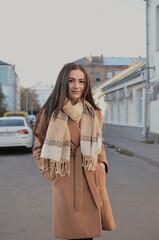 Cute girl standing on the autumn street. 