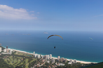 Paragliding flight over the beach