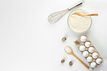 Eggs and quail eggs and sugar, coconut shavings in wooden spoons 