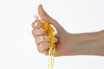 Brocken fresh egg in hand