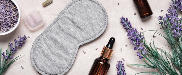 Healthy night sleep concept. Sleep mask and lavender products for healthy sleep on textile banner