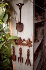 Agricultural tools hanging on the wall in the garden