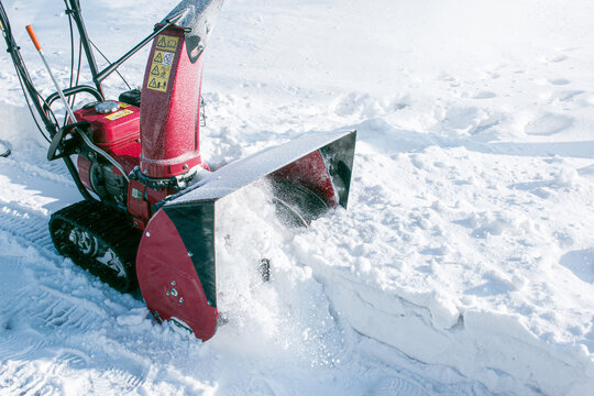 Tracked snow blower at work. After heavy snowfalls, snow is removed everywhere.