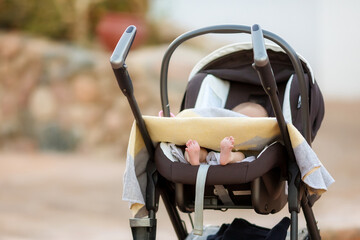 Newborn baby in his baby carriage. Closeup portrait of newborn baby. Baby goods packing template....