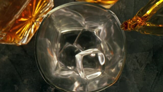 Super slow motion of pouring whiskey or rum with camera motion. Filmed on high speed cinema camera, 1000 fps.