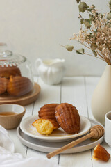 Madeleine cakes, french pastry. Served with cup of tea and honey. Breakfast. Copy space.