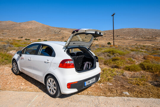Folegandros, Greece - September 25, 2020: Kia Rio car with open trunk parked along road on Folegandros island. Cyclades, Greece