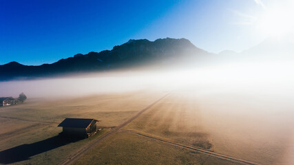 Lonely wooden house in foggy morning