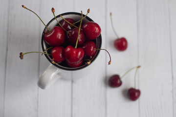 Ripe cherries in a white mug