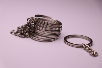 Silver plated split keyrings with chains isolated on white background. Group of keychain rings with chain