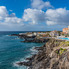 Fototapeta na wymiar Tropical island of Tenerife. Panorama of the Coastline with buildings with a pool