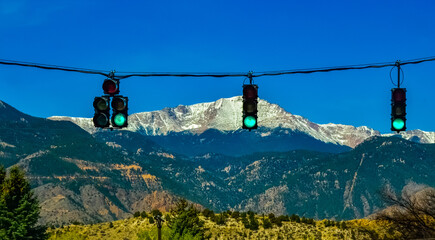 Traffic light on the background of snow-capped mountains. Pikes Peak Mountains in Colorado Spring,...