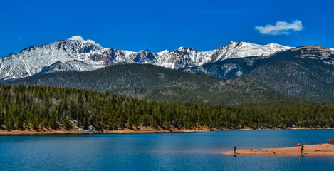 Panorama Snow-capped and forested mountains near a mountain lake, Pikes Peak Mountains in Colorado Spring, Colorado, US