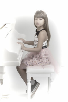 Lovely girl posing at white grand piano