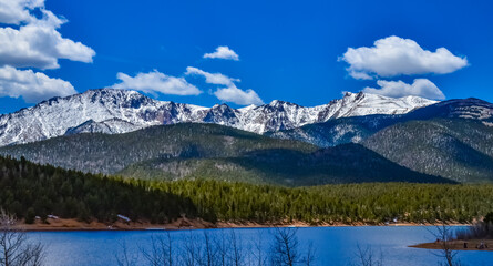 Panorama Snow-capped and forested mountains near a mountain lake, Pikes Peak Mountains in Colorado Spring, Colorado, US