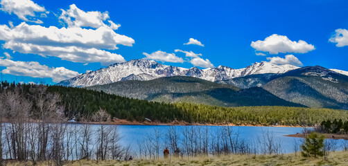 Naklejka na ściany i meble Panorama Snow-capped and forested mountains near a mountain lake, Pikes Peak Mountains in Colorado Spring, Colorado, US