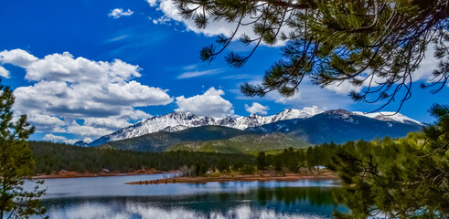 Panorama Snow-capped and forested mountains near a mountain lake, Pikes Peak Mountains in Colorado Spring, Colorado, US