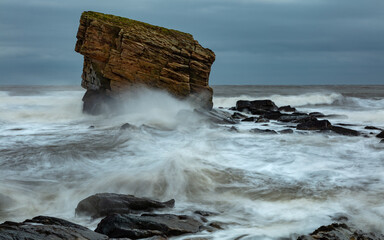 Rough sea at Charlies Garden, rock pillar in Colywell Bay, Seaton Sluice, Northumberland. Slow...