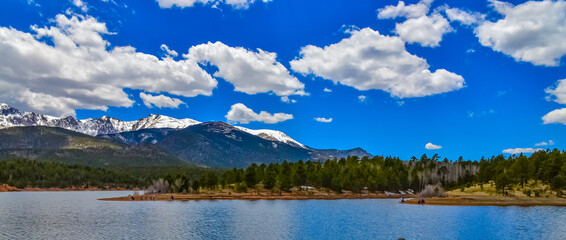 Panorama Snow-capped and forested mountains near a mountain lake, Pikes Peak Mountains in Colorado Spring, Colorado, US