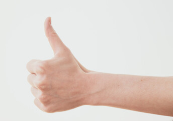 Female hand with thumb up gesture on white background.