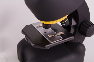 glass for analysis under a microscope with a sample on a white background