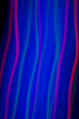 Blue smeared neon with red thin lines, on black background. Abstract line in high 

magnification. Red threads on blue and black background. Fancy background for lettering or 
graphics.