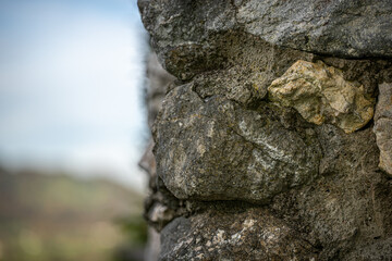 Texture of an old stone wall suitable for photo editing and wallpaper - the blue summer sky can be seen in the background
