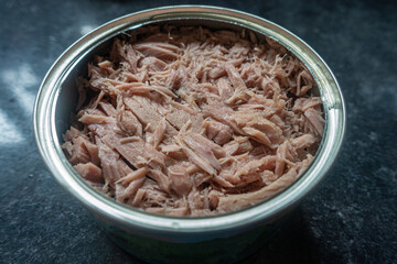 An open can of tuna chunks.